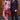 Two men in stylish suits with a red handbag and cane against a wooden background