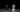 Black and white chess knights facing each other on a board