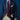 Man wearing a navy suit with a red tie against a blue background